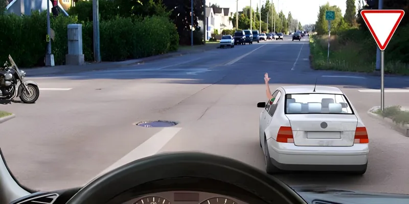 Question 19: What does the hand signal given by the passenger-car driver indicate?